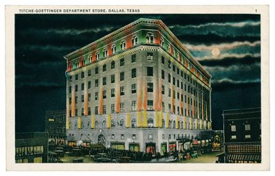 Titche-Goettinger Company Store Building (Dallas, Tex.): exterior view, corner perspective with cars at night