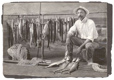Studio portrait of Herbert M. Greene with fish